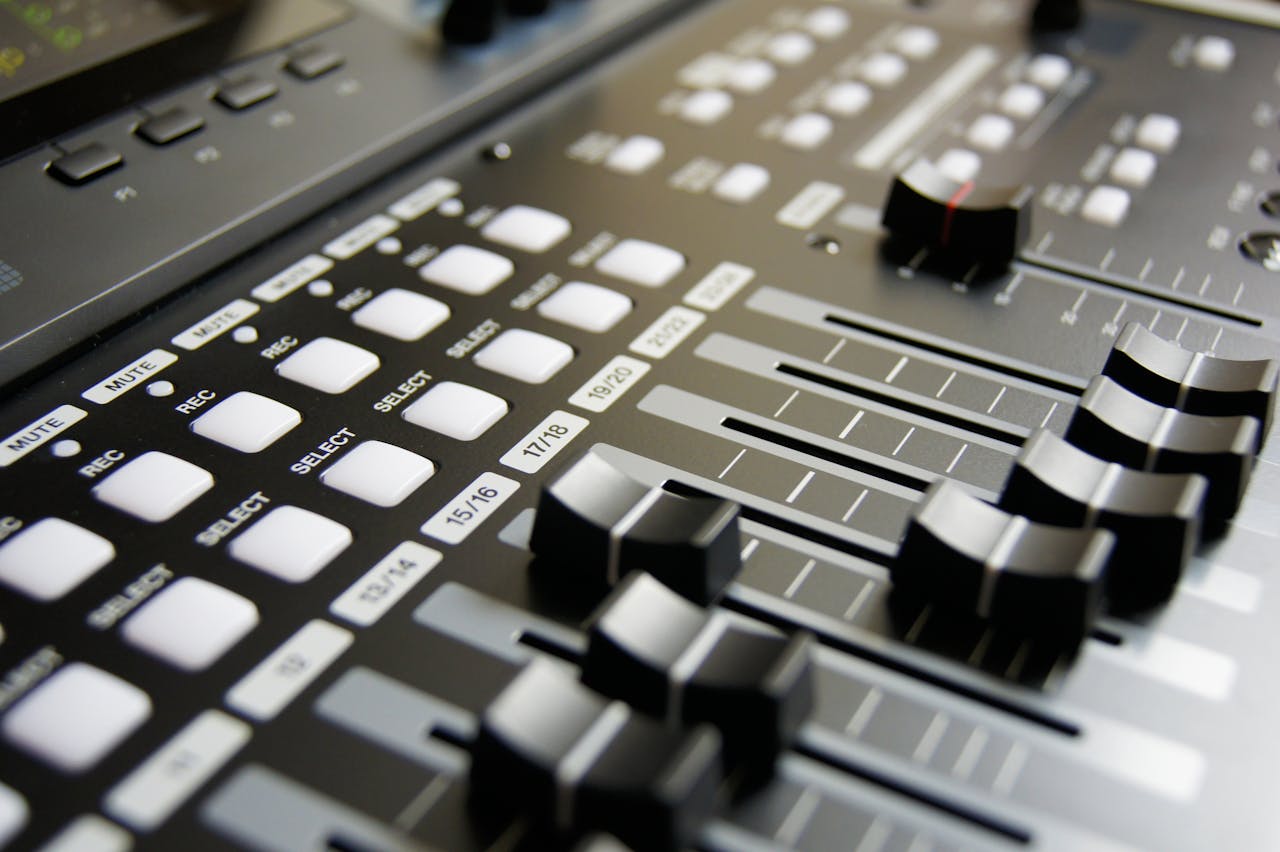 Detailed view of audio mixer sliders and buttons for sound engineering and music production.